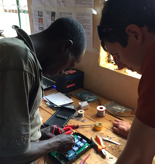 Image of two men working on a battery pack